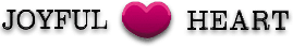 A pink heart is sitting on the ground.
