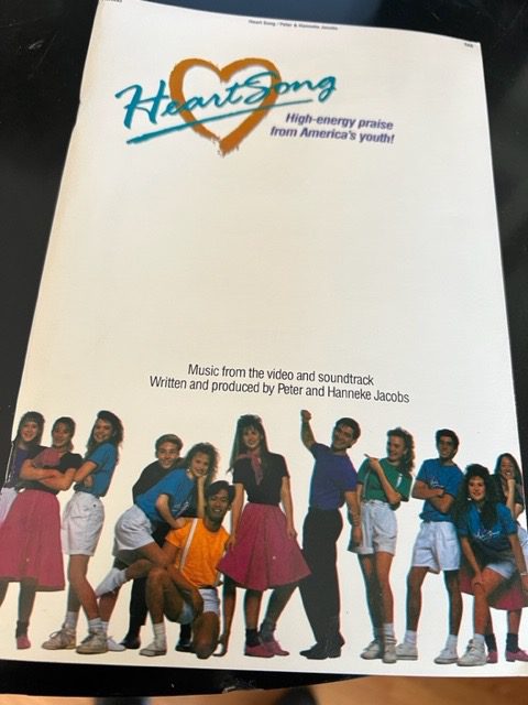 A book cover with people and the words " heritage."